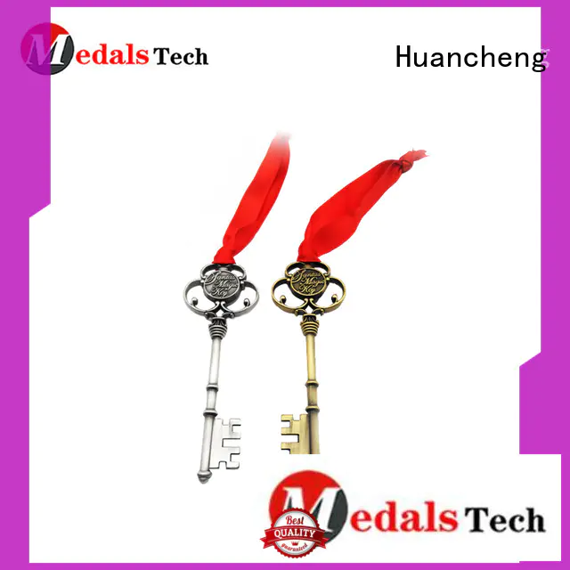 shiny silver metal logo Huancheng Brand name keychains supplier